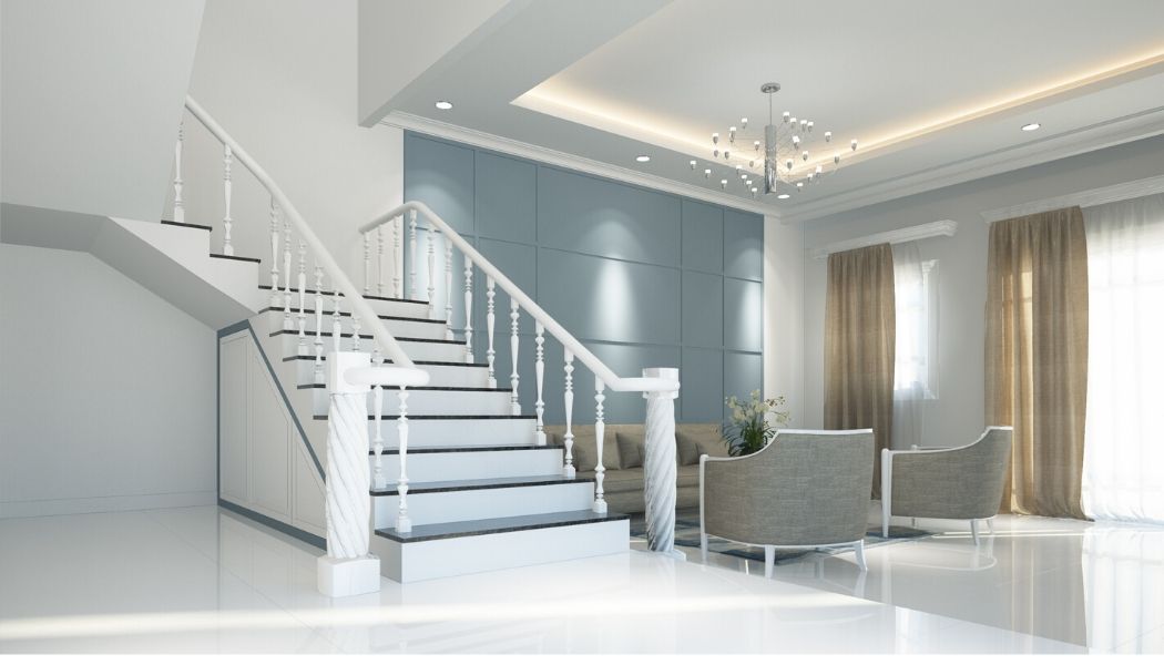 Beautiful staircase and reception area. White marble effect floor tiles with dark grey contrasting wall panel. Seating area  with uplighted ceiling and beige curtains. Main walls and ceiling painted white.